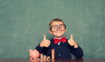kid with piggy bank giving two thumbs up