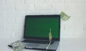 money on laptop
